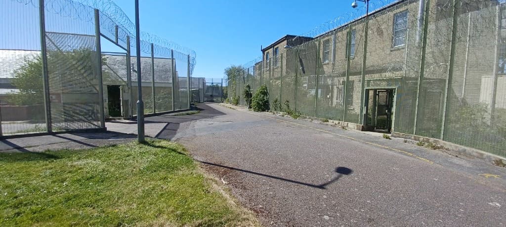 Curved asphalt road through the secured compound