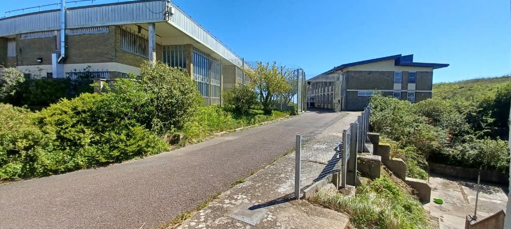Road between buildings with revetment and elevated positions